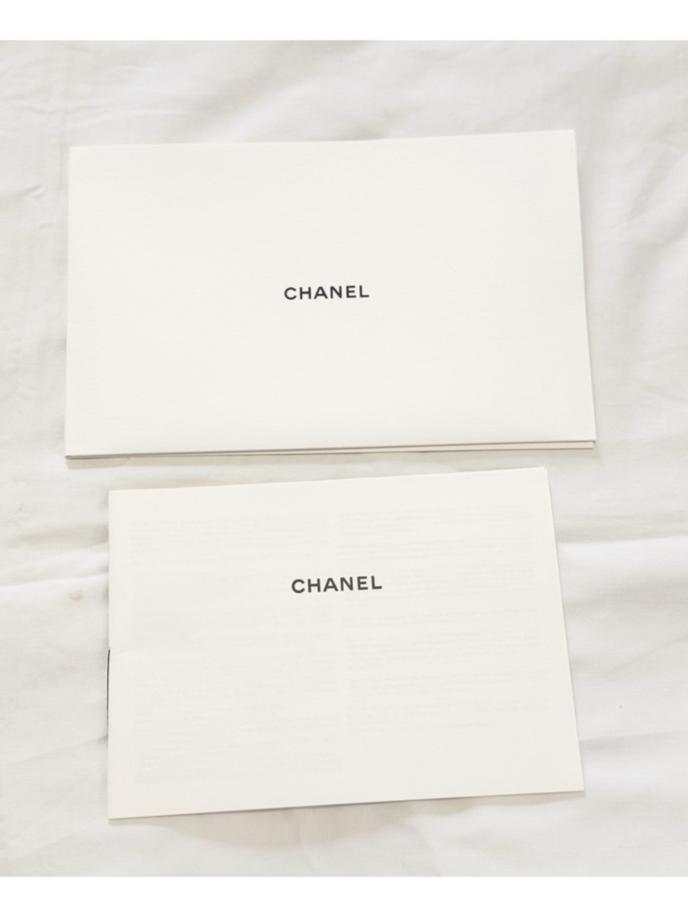 CHANEL White Booklet Pair with Black Logo